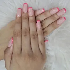 A classic French manicure with a pop of color. This design features clean, squared-off nails with a sheer pink base and vibrant, hot pink tips for a fun and modern twist.