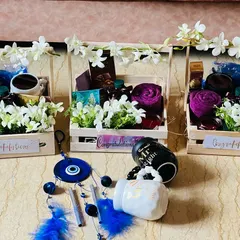 A set of three corporate wedding gift hampers for employees. These wooden crates are filled with flowers, home decor, and "Mr Right" & "Mrs Always Right" mugs.