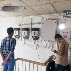 Our engineers inspecting the inverter setup for a multi-unit building. This critical component converts the DC power from your panels into AC power for your home, and we ensure it's configured for peak efficiency.