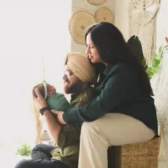 A warm, lifestyle family portrait with a newborn in our boho studio. The natural textures and earthy tones of the set create a cozy and inviting atmosphere for this family's first photoshoot.
