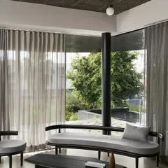 For the Pavilion House, we designed a serene retreat that merges with the landscape. This living area showcases our minimalist aesthetic, using a monochrome palette, curated black wood furniture, and expansive glass walls to create a tranquil space for contemplation and connection with nature.