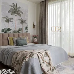 Here is the master bedroom at Casa Zen, a space designed for ultimate relaxation. The tropical-themed wallpaper serves as a serene focal point, complemented by a soft, tufted headboard and natural light that fills the room, creating a peaceful and airy atmosphere.