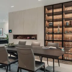 The formal dining area features a stunning, back-lit cutlery cabinet that serves as both storage and a piece of art. It reflects my philosophy of integrating beauty into the functional aspects of a home.