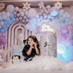 The birthday girl enjoying her magical Frozen party. We use soft, fluffy material to simulate snow, creating a perfect photo opportunity and a fun sensory experience for the kids.