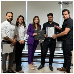 Our leadership team personally congratulates a graduate, awarding him his certificate of completion. This signifies his readiness to excel in the professional salon industry.