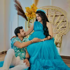 A quiet moment of connection between partners during their maternity shoot. Our popular boho-themed setup with the peacock chair provides a warm and relaxed backdrop for capturing these intimate memories.