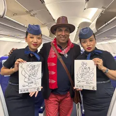 Posing with two Indigo flight attendants who are happily holding the custom sketches I drew for them during a flight from Chennai to Kolkata.