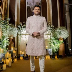 Styled to perfection in pink and white for the Godh celebration. We chose this Manish Malhotra ensemble with intricate threadwork for the groom, blending elegance with craftsmanship for a stunning statement.