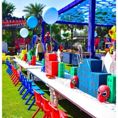 The kids' dining area was transformed into a superhero cityscape. I used custom table runners and centrepieces shaped like skyscrapers, along with character masks at each seat, to make even lunchtime part of the adventure.