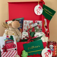 This Christmas hamper for kids is filled with holiday magic. It includes a plush reindeer, personalized stockings and ornaments, fun activity books, and of course, some sweet treats.