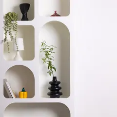 This wider shot of the arched shelving unit emphasizes its clean, geometric forms and its potential as a minimalist backdrop for product or portrait photography.