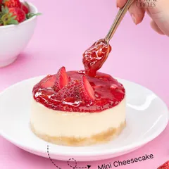 A beautiful mini strawberry cheesecake, perfect for a single serving of indulgence. The creamy cheesecake is topped with a fresh strawberry compote.
