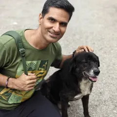 A photo of Hardik with a friendly dog, illustrating the yogic principle of Ahimsa (non-violence) and compassion for all living beings.
