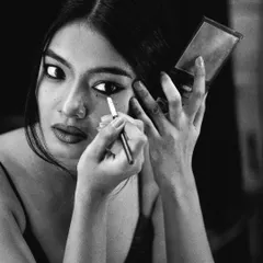 The mirror as a tool for transformation. This shot captures the intimate relationship between an actor and their reflection as they become someone else.