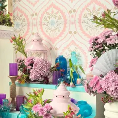 A pretty corner from the Kashmiri event, featuring pink lanterns, blue glass vases, and purple candles set against a traditional patterned wallpaper. These details added pops of color and local flavor.