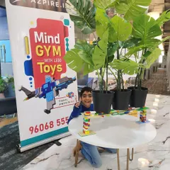 Success! A young engineer tests the strength of a bridge he constructed entirely from LEGO bricks, proving that play can teach real-world physics and engineering principles.
