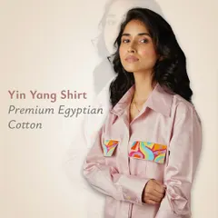 The Yin Yang Shirt in premium Egyptian cotton. This version comes in a beautiful pink, with two art-detailed pockets that add a playful and balanced touch to the luxurious fabric.