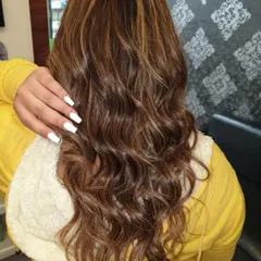 A great example of hair coloring and styling. This client wanted rich, natural-looking highlights with soft waves. You can see the dimension in the color and the healthy shine of the hair after the service.