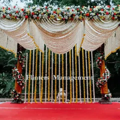 A truly grand and traditional mandap. We used drapes of tuberose and marigold, with pillars wrapped in colorful flowers, to create a classic and opulent setting for the wedding ceremony.