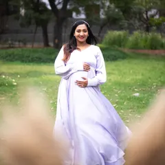 A solo maternity portrait is a beautiful way to celebrate your journey. This mom-to-be is wearing a flowy lavender gown that catches the light perfectly in this outdoor park setting. I guide my clients with simple movements, like a gentle twirl, to create images that feel joyful and full of life.