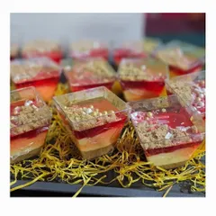 Our beautiful layered custard pudding, a festive dessert that is as delicious as it looks. Topped with jelly and crumble, it's a perfect sweet treat for a Christmas party.