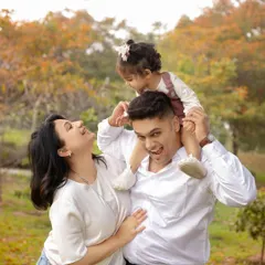 Laughter and fun in the park. Outdoor family photoshoots are perfect for capturing genuine, energetic moments like this.