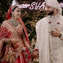 A beautiful candid moment between the bride and groom on their wedding day in Delhi. The neon sign in the background adds a modern touch to this heartfelt, traditional moment.