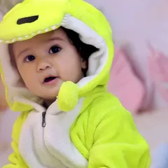 A close-up of the adorable dinosaur costume we provide for the shoot. The soft, comfortable outfit allows the baby to move freely while perfectly fitting the theme.