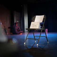 A simple chair on our stage, marked for a "Fluid Sculpture" exercise, showing how even the simplest props can create magic in our black box.