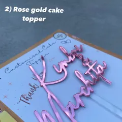 A close-up of a "Kimbri & Marchita" topper in our beautiful rose gold mirror finish, a warm and trendy alternative to classic gold.