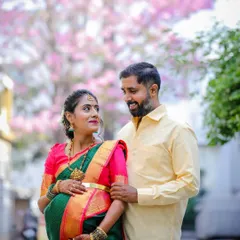 A romantic outdoor maternity shoot for a couple, set against the beautiful backdrop of Bangalore's blooming Tabebuia trees. This session highlights a natural, candid style that captures the couple's connection.