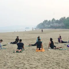 Students in my beach class practice Bhujangasana, or Cobra Pose, in a circle on the sand. This foundational backbend is excellent for strengthening the spine, opening the chest, and improving posture, with the fresh sea air enhancing every breath.