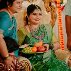 A beautiful candid moment from a Sreemantham, where the mother-to-be is presented with a plate of fruits as part of the ceremony, surrounded by loved ones.