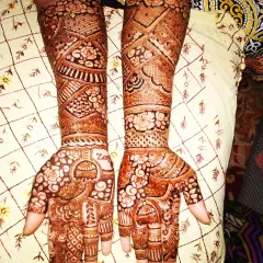 I did this henna for my best friend for her brother's wedding. It features a beautiful jhumka design on the palm and intricate work up the arm, perfect for a close family member.