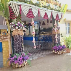 The same beautiful entrance seen in bright daylight, showing the natural colors of the flowers and leaves.