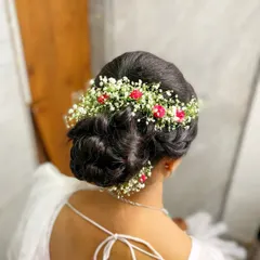 A detailed shot of the bridal hairstyle for my Buddhist bride. This intricate bun woven with delicate fresh flowers added a touch of romance and elegance to her overall look.