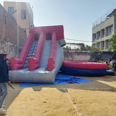 This is a custom inflatable game featuring a steep slide and a separate landing pit. We can design and manufacture unique inflatable games for any purpose.