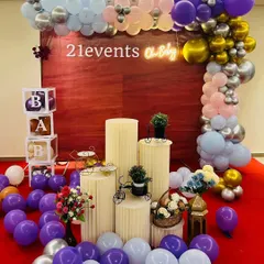 An 'Oh Baby' shower theme with a purple, silver, and pastel blue color scheme. The scattered balloons on the floor and 'BABY' blocks add a playful touch.