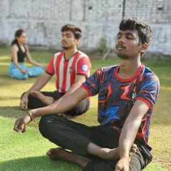 Athletes take a moment to center themselves with meditation at our outdoor park. Connecting with your breath is a key part of our training philosophy.
