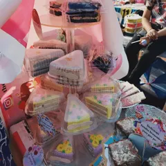A display of my flavored pastry slices at an exhibition. Each slice is individually packed and comes in different flavors with beautiful, delicate frosting designs.