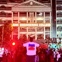 A wide shot from my perspective on stage at AMC Engineering College. Seeing a sea of students with their hands up, completely lost in the music, is an incredible sight.
