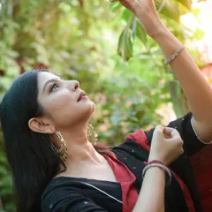 A profile shot looking up towards the light, captured in a natural, green setting. This portrait evokes a sense of hope and connection with nature.