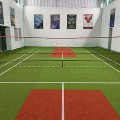 Another angle of our court. The red and green turf is different from wood but gives a great bounce for fast rallies.