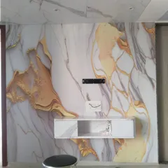 A custom wallpaper that mimics the look of white and gold marble. This design covers the entire TV wall and ceiling portion for a luxurious, continuous look.