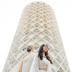 Your love story is a masterpiece, and it deserves a frame that is just as epic. I love finding unique perspectives, like using the stunning architecture of the venue to create a modern, powerful portrait that feels both grand and intimate.