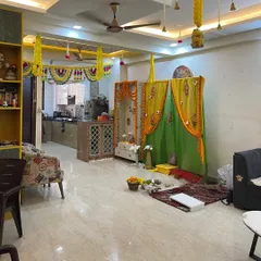 This is how I integrate a festive pooja or ceremony area into the living room. The yellow and green drapes and marigold garlands make the whole house feel connected and celebratory.