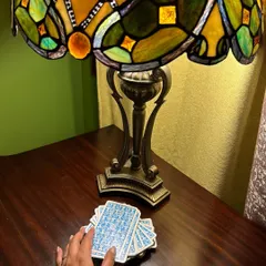 Tarot readings offer valuable insights into all areas of life. This image captures the quiet, introspective mood of a session, with the cards laid out under the warm glow of a Tiffany lamp, ready to offer a fresh perspective.