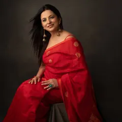 A woman in a red saree is a vision of grace and power. This portrait captures her elegance and the timeless beauty of this classic Indian attire.