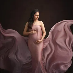 A dramatic and artistic maternity portrait. The makeup is kept soft and natural to emphasize the beauty and strength of the mother-to-be.