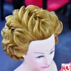 This is an example of the advanced hairstyling techniques I teach and offer to my clients. This particular style is a voluminous, sculpted updo perfect for a reception or grand event. Creating these structured, elegant looks is a passion of mine.